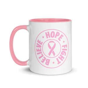 White glossy ceramic coffee mug printed with a pink circular logo containing the text Believe Hope Fight Breast Cancer and a pink ribbon in the center.
