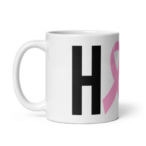 White ceramic coffee mug featuring large black letter H alongside a prominent pink breast cancer ribbon representing the O in HOPE.