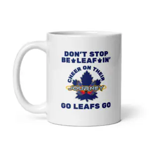 White ceramic coffee mug featuring blue text reading "DON'T STOP BE-LEAF-IN'", a blue maple leaf graphic with "JOURNEY", and "GO LEAFS GO" at the bottom.