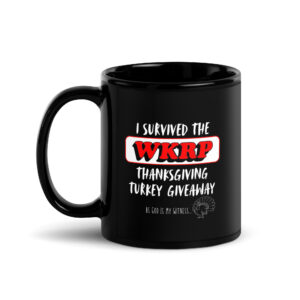 Black mug with humorous Thanksgiving message about WKRP turkey giveaway.