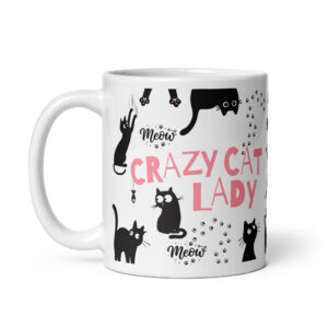White ceramic coffee mug with black and pink cat-themed design and text.