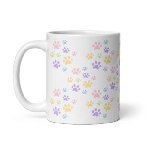 White ceramic coffee mug with colorful paw print pattern for pet lovers.