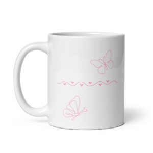 White ceramic coffee mug with pink butterfly and heart design for breast cancer awareness.